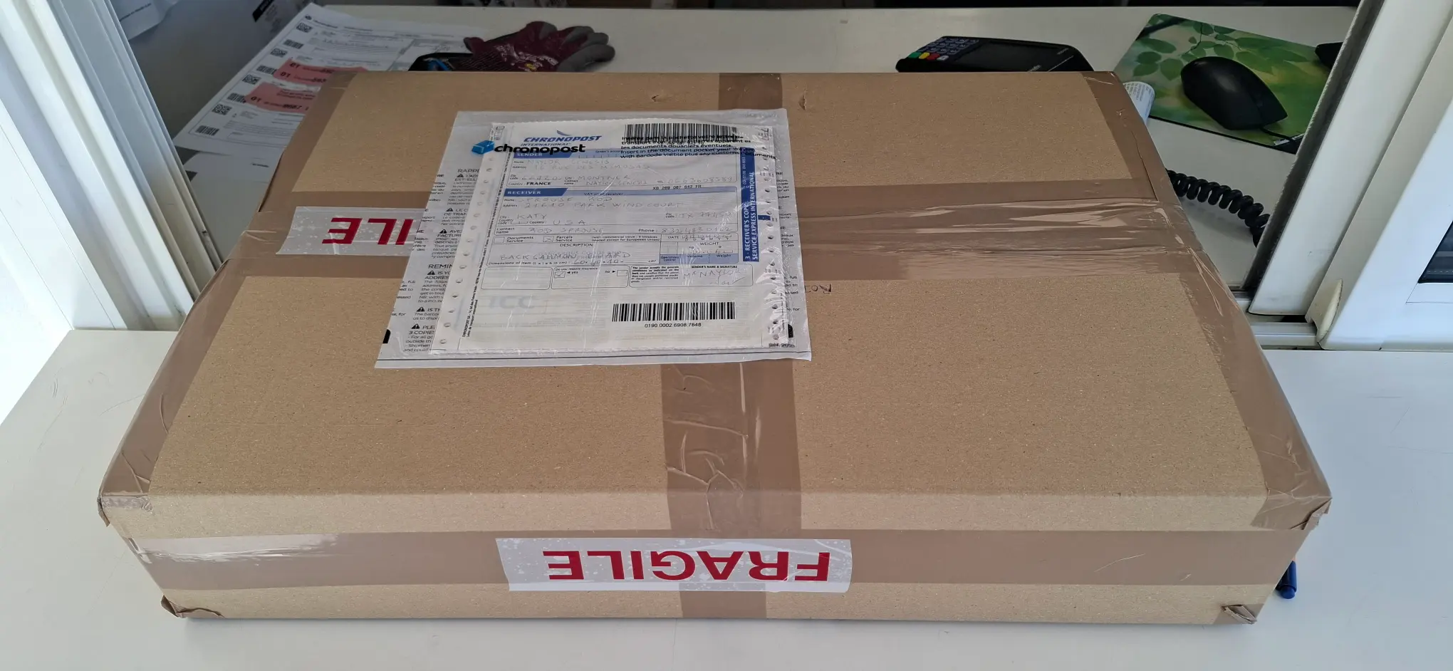 Luxury backgammon board package with international shipping label, ready for delivery.